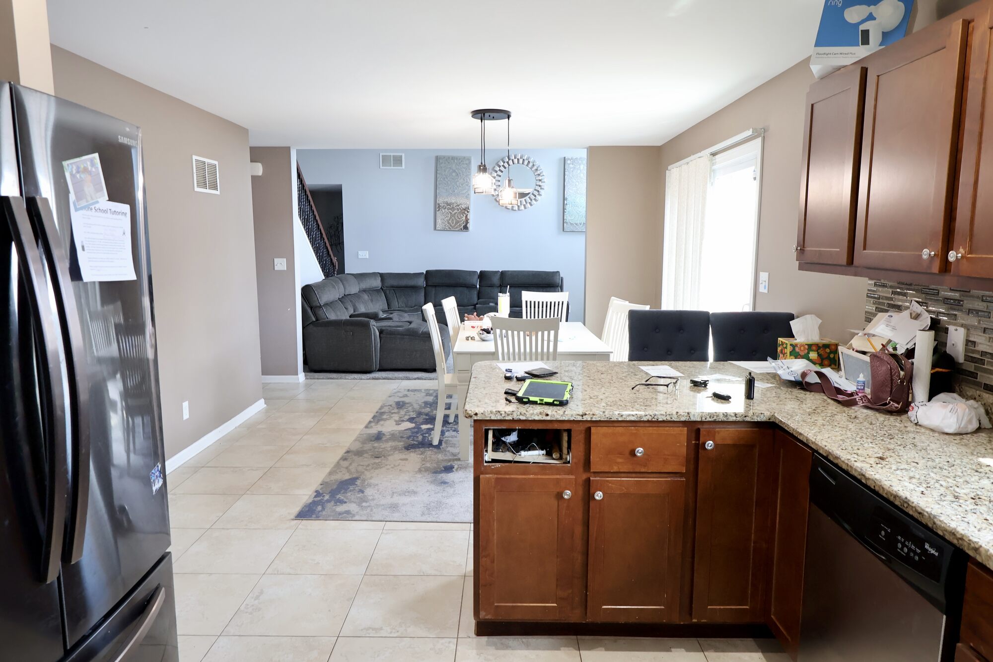 Transitional space connecting kitchen and family room in Schererville custom home by Clear Contractors.