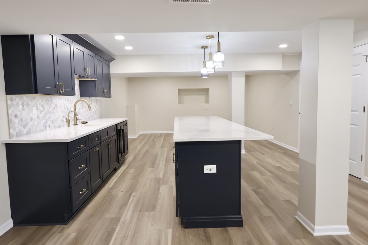 Navy and gold kitchen design in basement remodel by Clear Contractors in Crown Point, IN