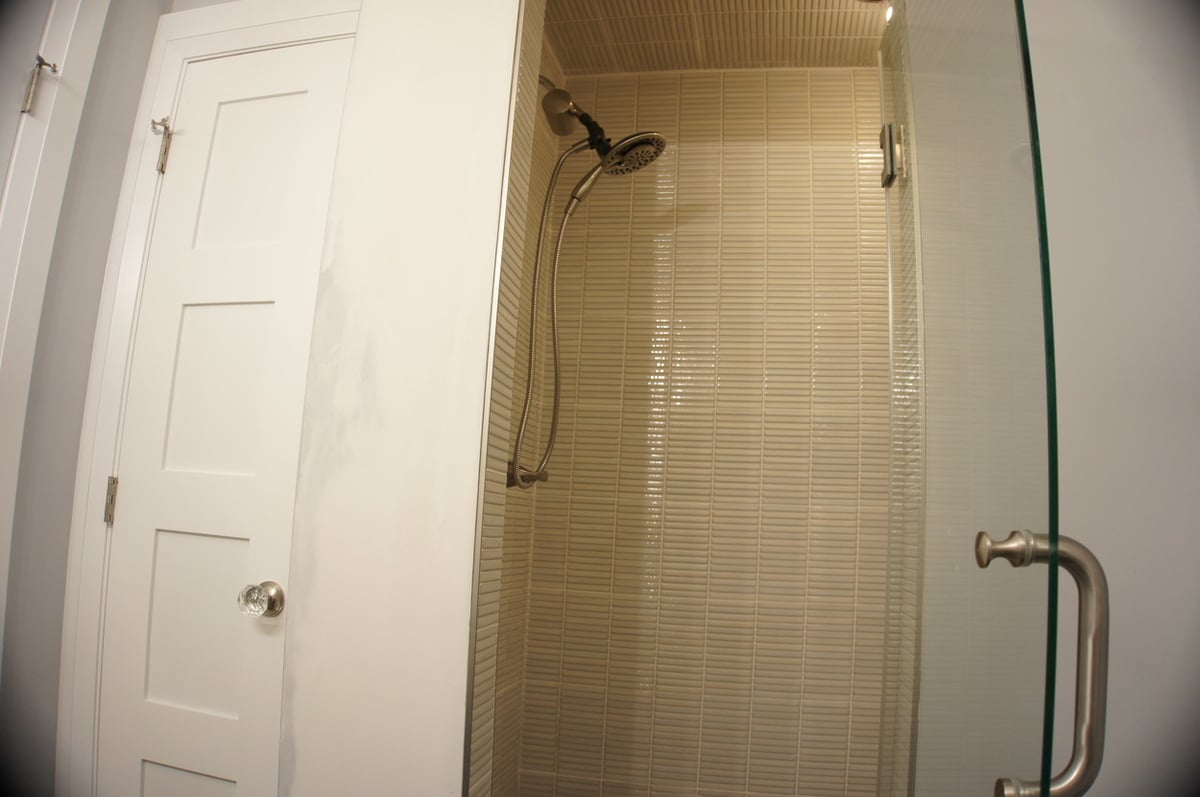 Beige tile shower with rainfall showerhead for Basement + Bathroom Remodel in St. John
