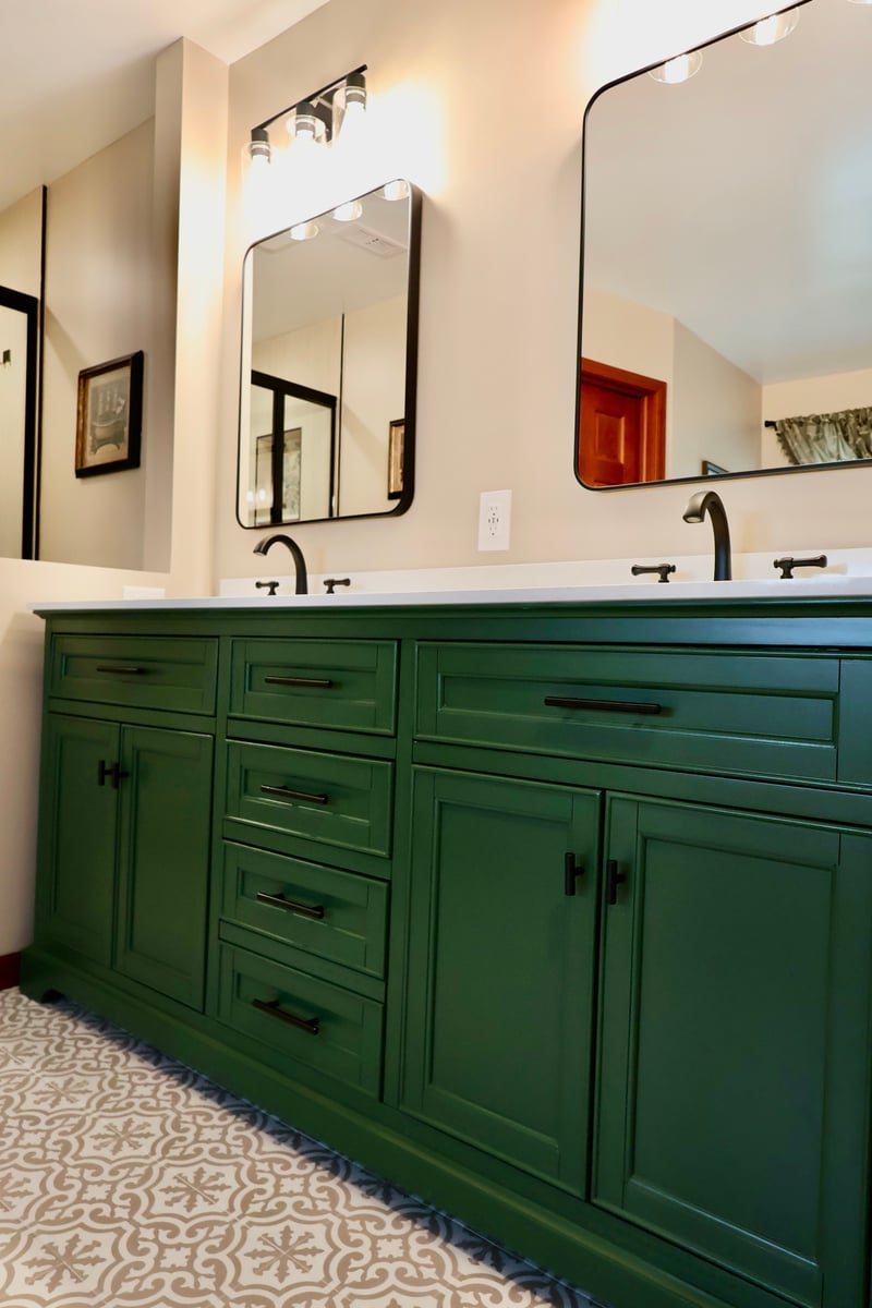 Close-up of green double vanity with white countertop in Lowell bathroom remodel