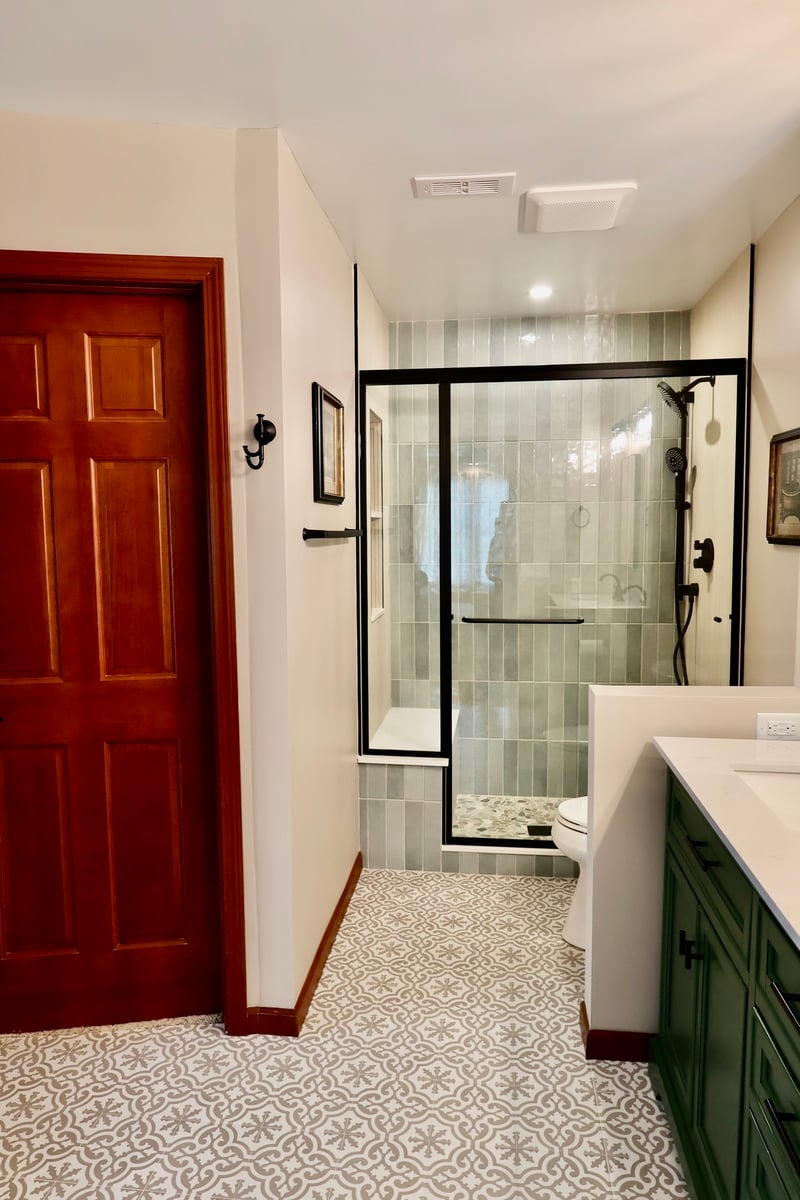 Full view of remodeled Lowell bathroom with green vanity and walk-in shower