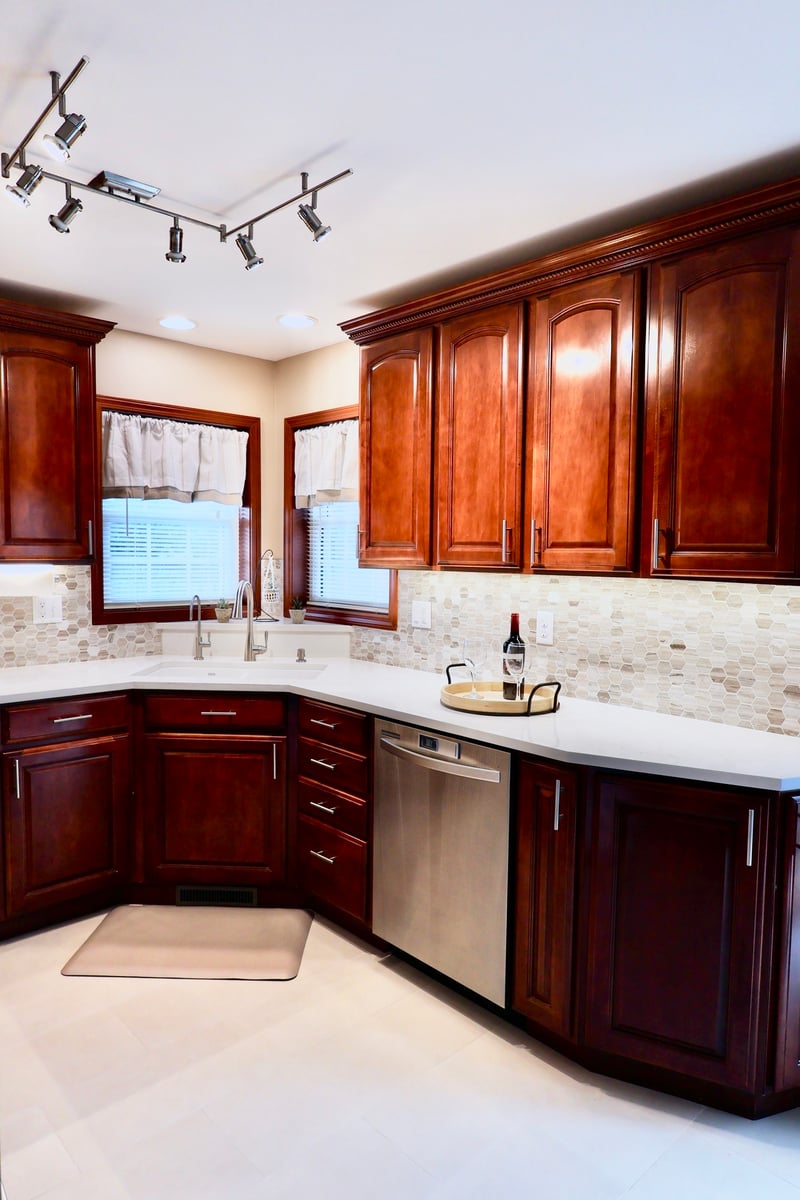Modern Lowell kitchen with dual windows, white countertops, and subtle backsplash design
