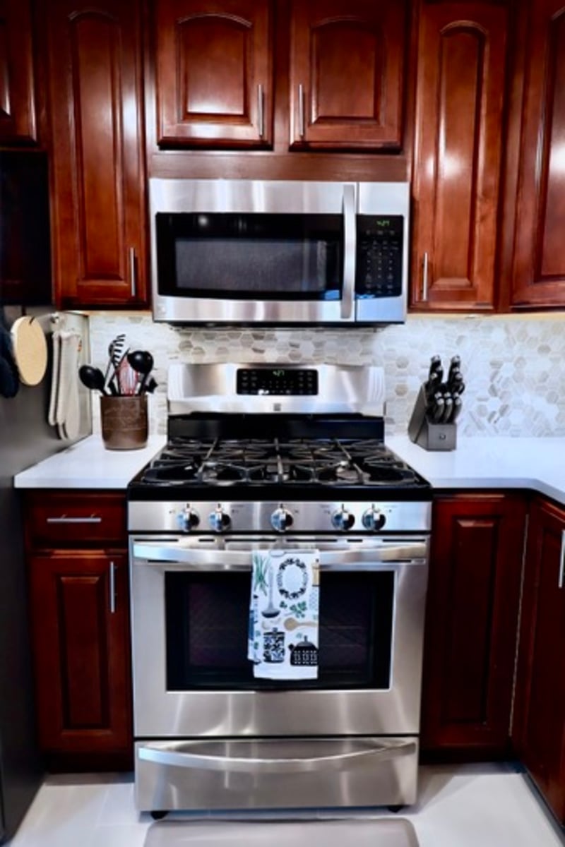 Stainless steel range and microwave in kitchen remodel in Lowell.