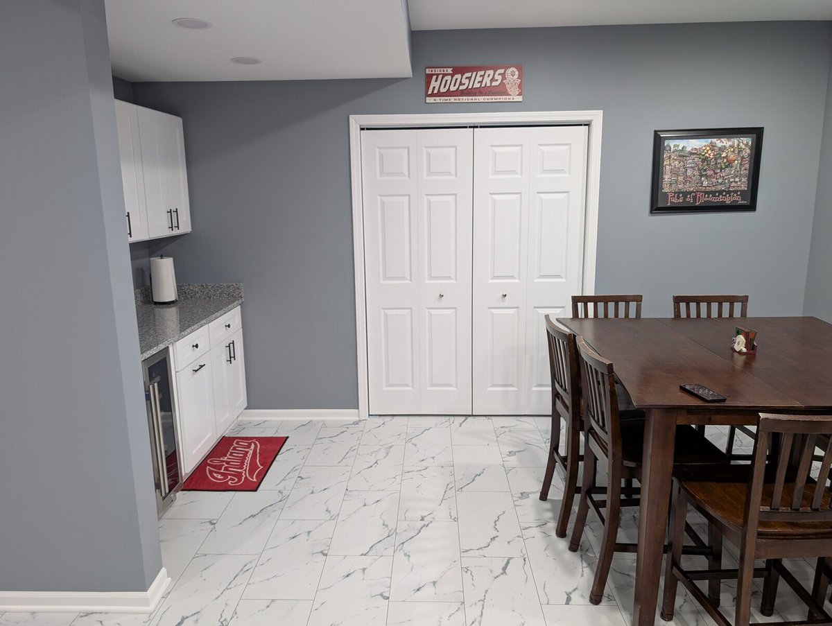 Finished basement dining space with modern cabinets and decor by Clear Contractors in Northwest Indiana