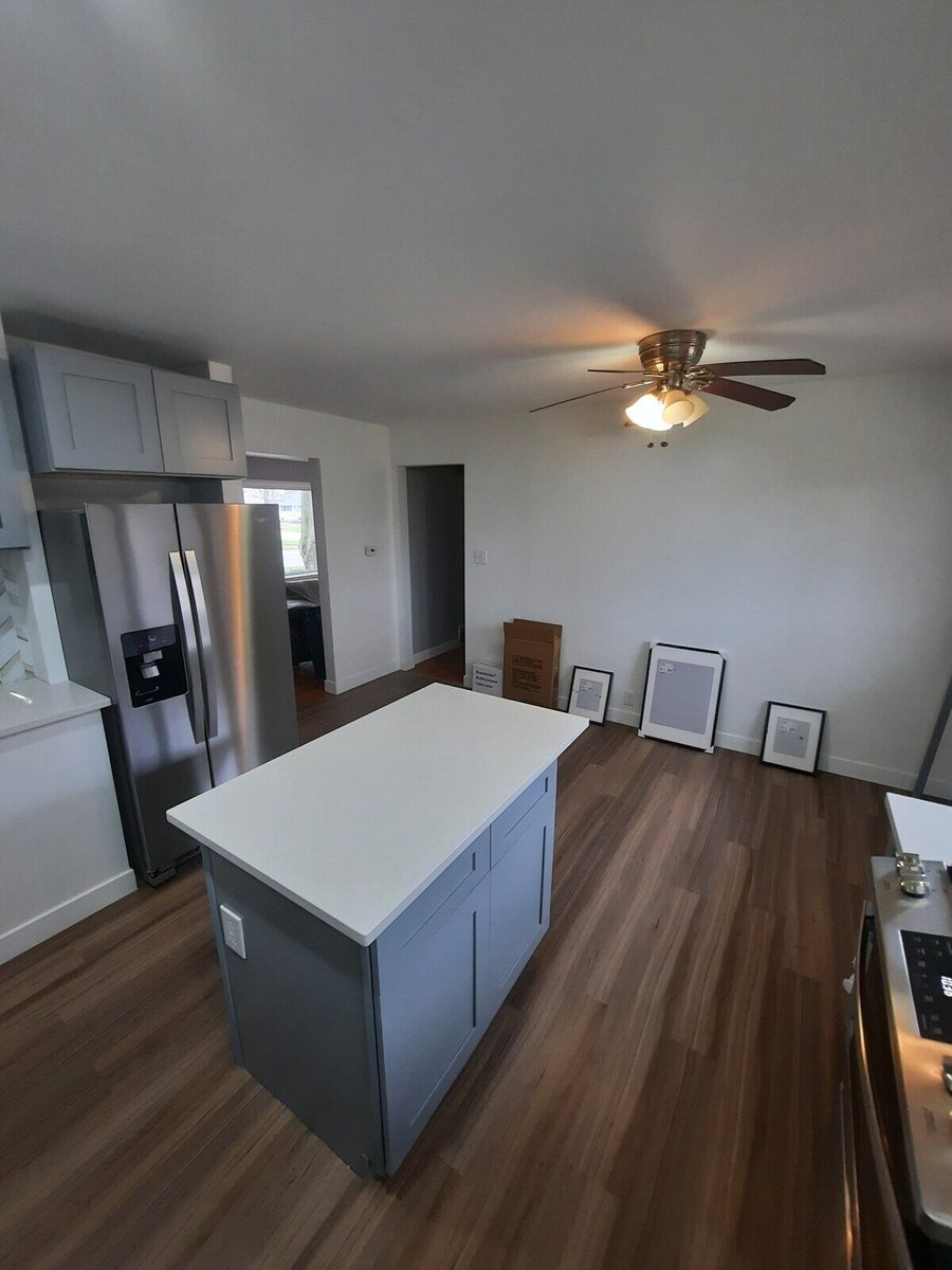 Open kitchen layout with a central island and wood floors, remodeled by Clear Contractors in Northwest Indiana