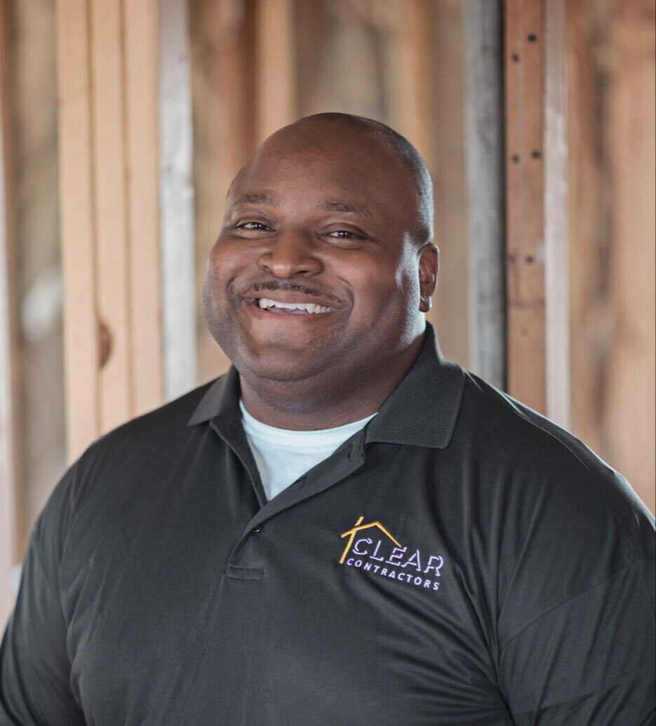 Lorenzo Richard II, an employee of Clear Contractors, smiling on a construction site in Northwest Indiana