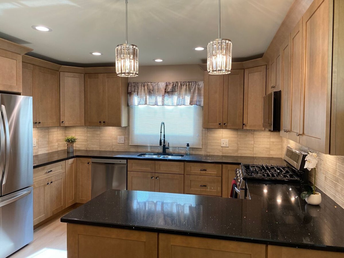 Wide-angle view of transitional kitchen with dual pendant lights in a kitchen remodel in Lynwood by Clear Contractors