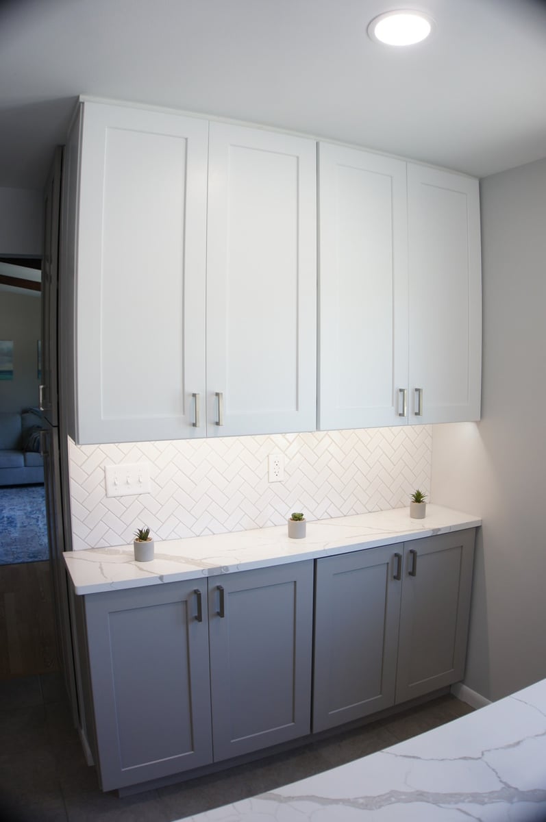 Built-in cabinetry with white quartz and under-cabinet lighting for Kitchen Remodel in Munster