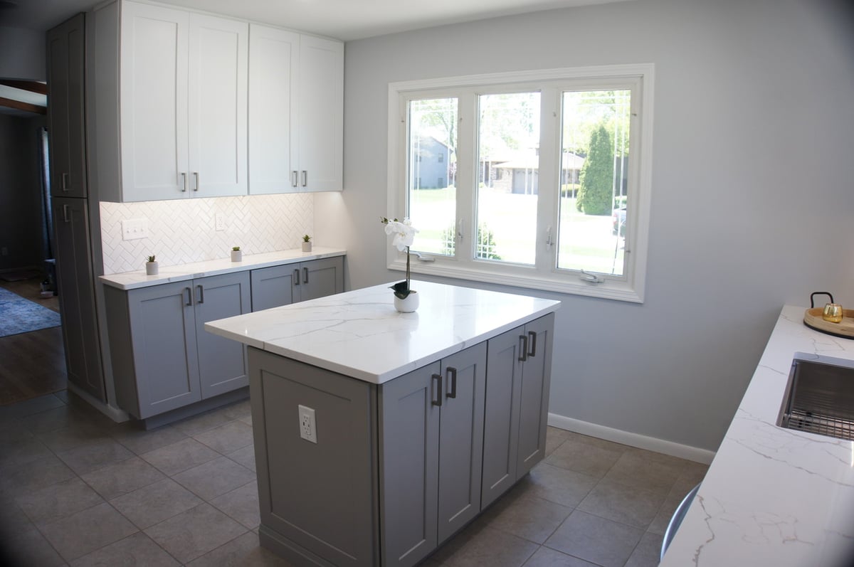 Modern kitchen design with white and gray cabinetry for Kitchen Remodel in Munster