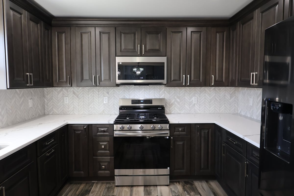Custom kitchen with stainless steel appliances and espresso cabinets by Clear Contractors in Schererville, IN.