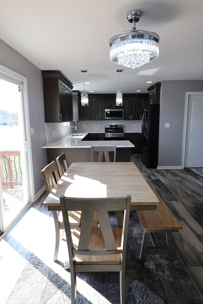 Dining area with bench seating beside modern kitchen in a Clear Contractors custom home in Schererville, IN.