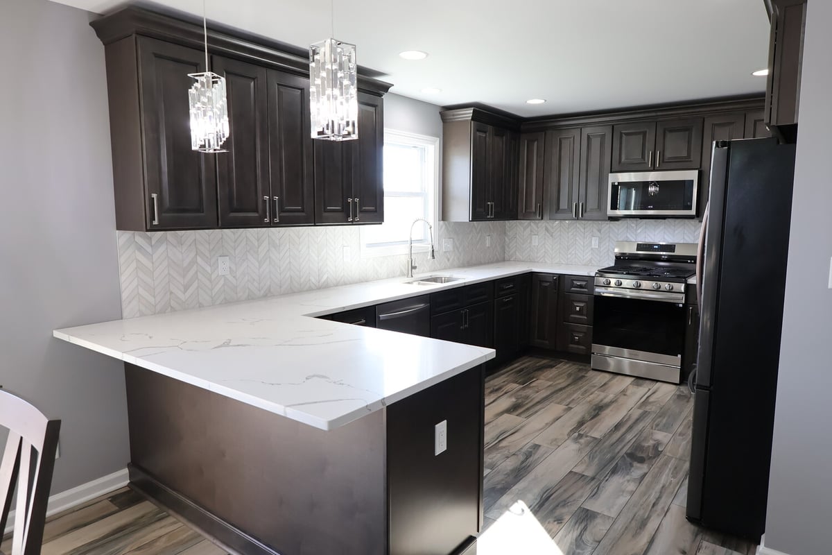 Functional kitchen design with under-cabinet lighting and stainless appliances by Clear Contractors in Schererville.